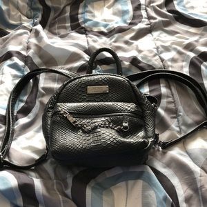 BCBG Paris black “snakeskin” backpack